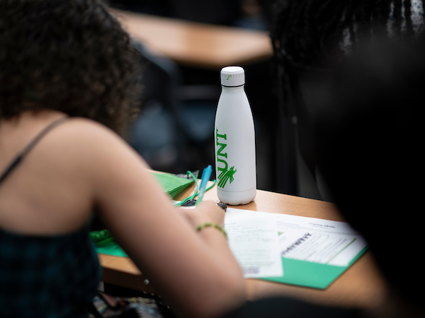 A student filling out a form at a desk